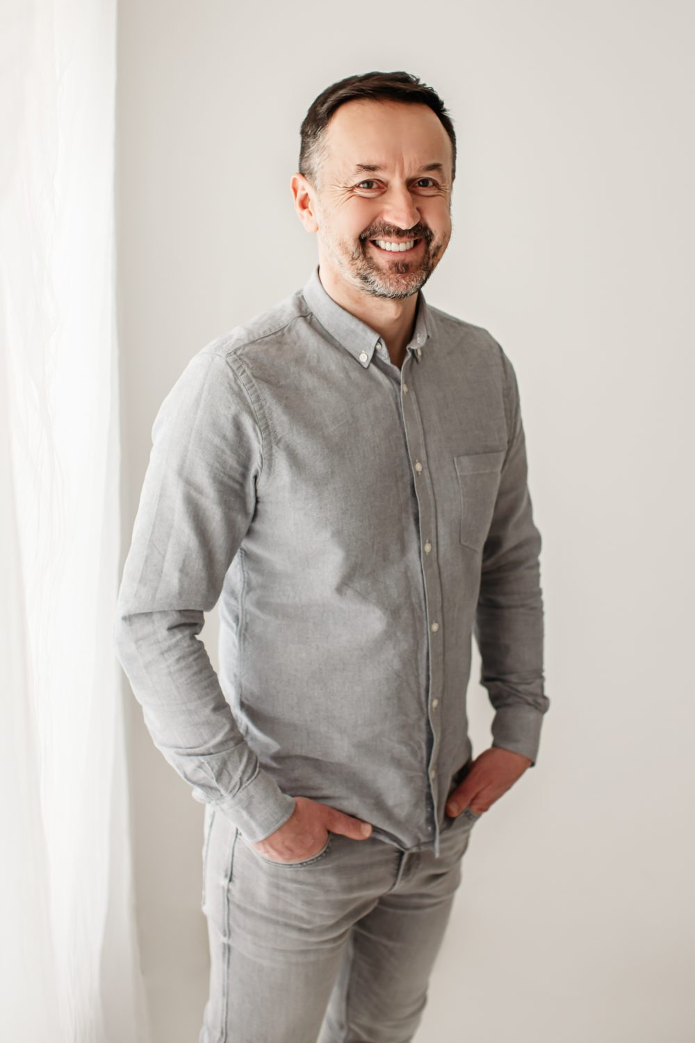 Piotr Kardas standing in a bright studio